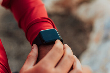 Man Using A Digital Smartwatch During Workout. Closeup View Of Man's Hands Checking An App In Smartwatch. Close-up Of A Clock That Shows Steps, Kilometers And bpm.