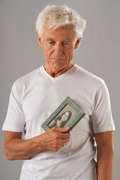Man Holding Photograph