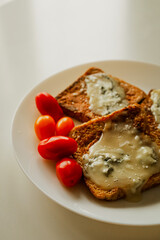 Sandwich with melted cheese. And cherry tomatoes. The quick breakfast of millennials. Morning food.