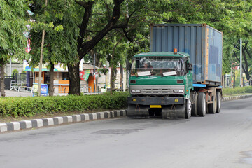 Old trailer trucks are still used on the roads in Asia.