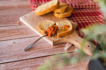 Top view of ajvar paprika spread on slice of bread for breakfast during the day salty snack healthy and vegetarian