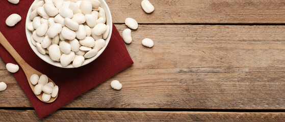 White beans and space for text on wooden table, flat lay. Banner design