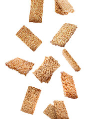 Many puffed rice bars (kozinaki) falling on white background