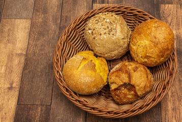 Round bread rolls of different flours in a wicker basket