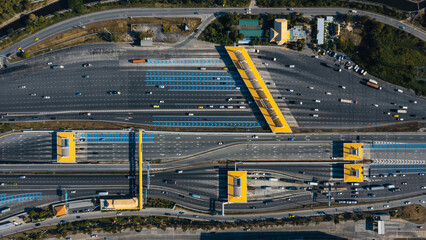 Aerial view of Cars Passing Through The Automatic Point Of Payment On motorway Toll Road at night. Point Of Toll Highway, Toll Station. Highway Toll Plaza Or Turnpike Or Charging Point, Expressway