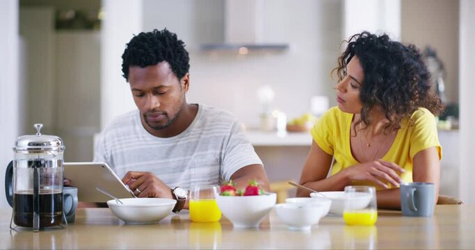 Morning, couple and tablet to ignore fight with partner at breakfast table after argument. Interracial, marriage and frustrated woman asking for attention from rude husband on social media.