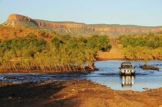 SUV Crossing Pentecost River with Cockburn Ranges in Background, Gibb River Road, Kimberley, Western Australia, Australia