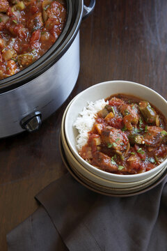 Slowcooker gumbo with rice on wood table