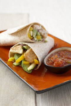 Fish with peppers and cucumber in a whole grain wrap
