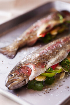 Whole fish stuffed with ginger, lime, chili and garlic on a roasting pan