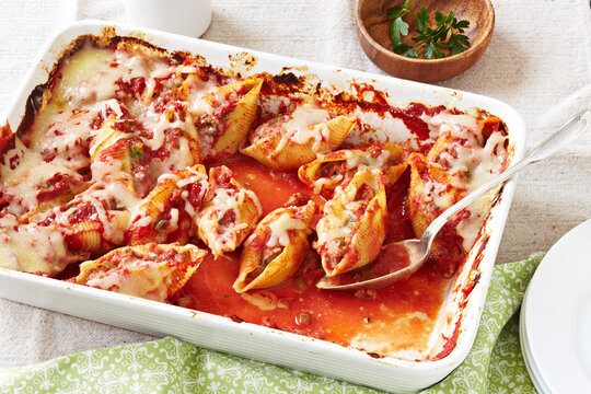 Large conchiglie pasta shells stuffed with sausage and baked with cheese