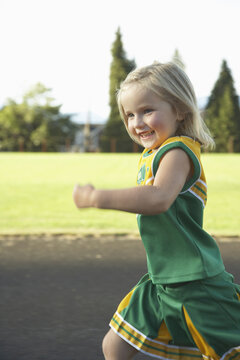 Girl Dressed as Cheerleader Running