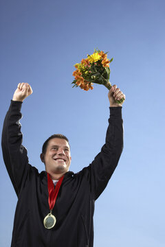 Man with Medal and Holding Bouquet