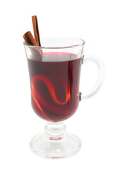 Mulled wine in a glass with spices isolated on a white background.