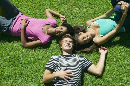 Teenagers Lying on Grass