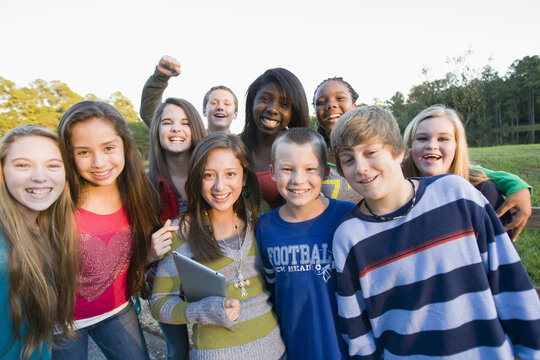 Group portrait of pre-teens standing outdoors, smiling and looking at camera, Florida, USA
