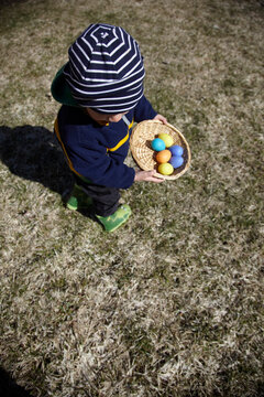 Boy Holding Basket with Easter Eggs