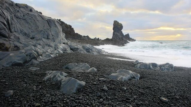 Icelandic Coastline with Black Cliff at Sunset, Volcanic Rocks with Blue North Atlantic Ocean Water, Shot in 8K Resolution 4320p
