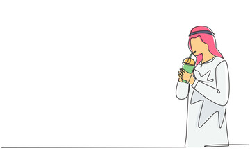 Single one line drawing side view of young Arabian man using straw and drinking smoothie juice from plastic cup. Make him refreshing in summer. Continuous line draw design graphic vector illustration