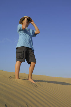 Boy Looking Through Binoculars, Playa del Ingles, Cran Canaria, Canary Islands