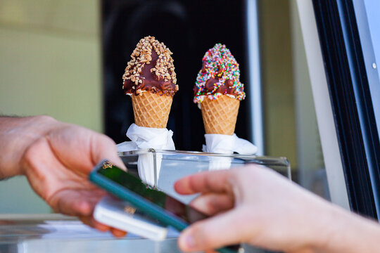 tap to pay transaction on phone to buy ice cream dessert