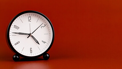 Alarm clock on red background, time concept