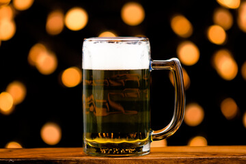 Glass of beer, alcoholic drink, isolated bokeh background. light to party