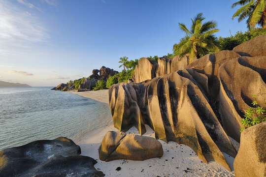 Rock Formations and Palm Trees near Sunset, Anse Source d&acute;Argent, La Digue, Seychelles