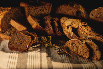 Bread, traditional sourdough bread, cut into slices on a rustic craftpaper background. The concept of traditional ways of baking yeast bread. Background for advertising
