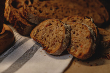 Bread, traditional sourdough bread, cut into slices on a rustic craftpaper background. The concept of traditional ways of baking yeast bread. Background for advertising