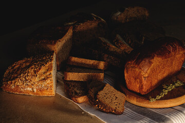 Bread, traditional sourdough bread, cut into slices on a rustic craftpaper background. The concept of traditional ways of baking yeast bread. Background for advertising