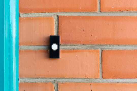 Fototapeta Doorbell on red brick house