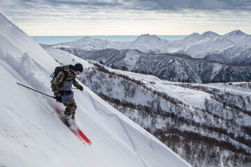 incredible skiing in the snowy Caucasus mountains, good winter day, freeride in a deep snow, ski season