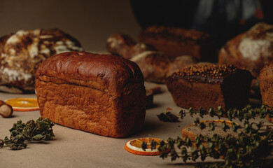 Baguette and different types of sourdough kraft bread on kraft paper background
