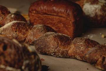 Baguette and different types of sourdough kraft bread on kraft paper background