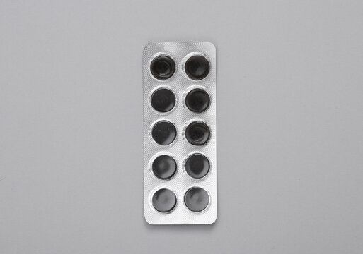 Blister of activated carbon on a gray background