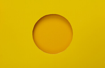 Round hole in paper, yellow background