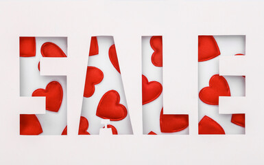 Word sale cut out of paper hole with hearts on white background. Valentine's day, love, sale concept