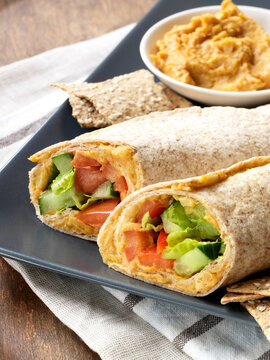 Vegetarian Hummus Wraps Served on Platter with Hummus Dip and Crackers