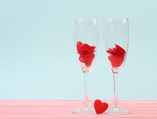 Two glasses with hearts on a pastel background. Valentine's Day, February 14