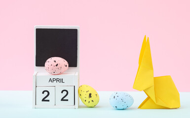 Happy easter. Calendar with date april 22 and easter  rabbit with eggs on pastel background