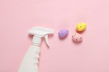 Detergent spray bottle with easter eggs on pink background. Creative layout. Holiday concept
