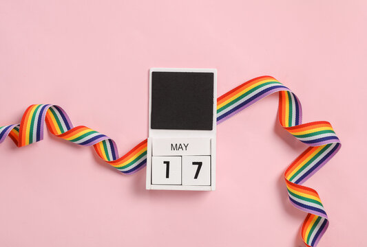 International day against homophobia. May 17 date calendar with lgbt rainbow ribbon on pink background