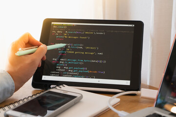 Young asian man programer developer coding software about intelligence innovation. Young man programmer writes program code on a computer. home office .