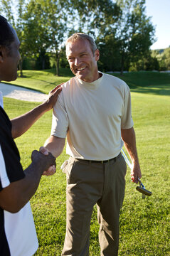 Friends Shaking Hands on Golf Course, Burlington, Ontario, Canada