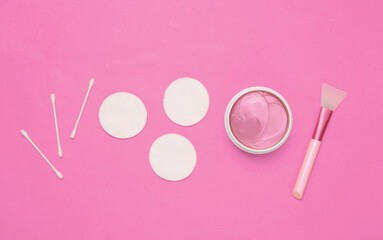 Facial care products on pink background. Top view