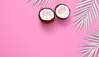 White palm leaves with coconut on pink background. Creative tropical layout. Copy space