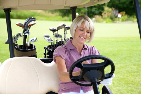 Woman Sitting in Golf Cart