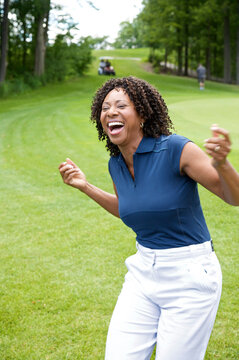 Woman Laughing on Golf Course