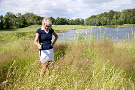Golfer Searching for Ball in Tall Grass